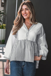 Woman wearing a striped babydoll blouse.