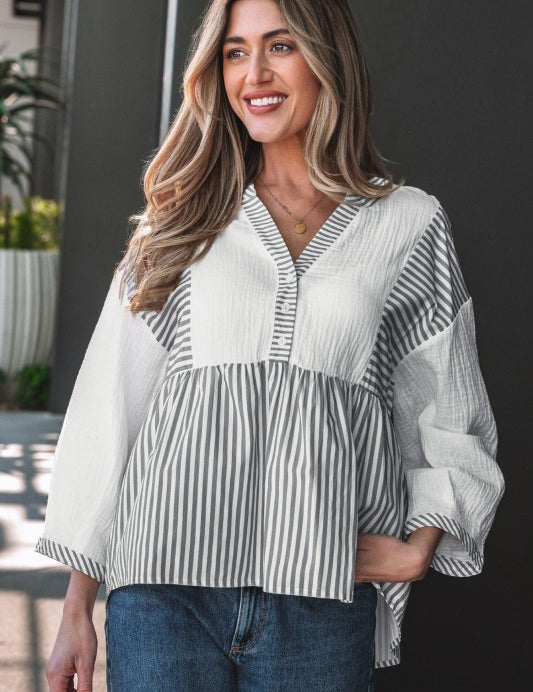 Woman wearing a striped babydoll blouse.